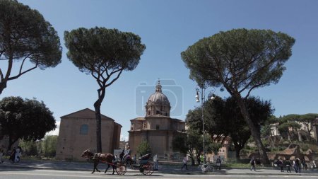 Photo for Europe, Italy , Rome 2023 - Fori Imperiali ( Imperial Forums ) Ara Paris - Antique historic Roman ruins of ancient Rome - Unesco Heritage World - tourist visiting sightseeing in horse with carriage - Royalty Free Image
