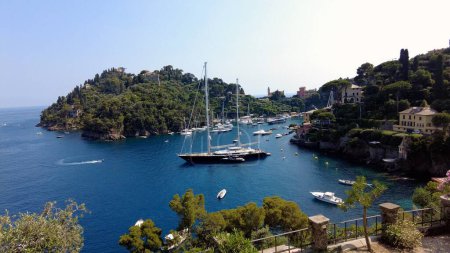 Photo for Europe, Italy, Portofino - The bay of Portofino in Tigullio Mediterranean sea national natural reserve park near Genoa - the harbour with boats and yachts - amazing nature with purple bougamvillea - Royalty Free Image