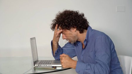 Photo for Stressed man working on a computer at work, worried man - Royalty Free Image