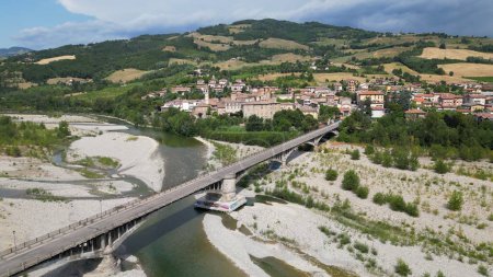 Photo for Europe, Italy , Emilia Romagna Val Trebbia - drone aerial view of river drought and aridity water emergency - climate change and global warming - car on the bridge over empty river - Royalty Free Image