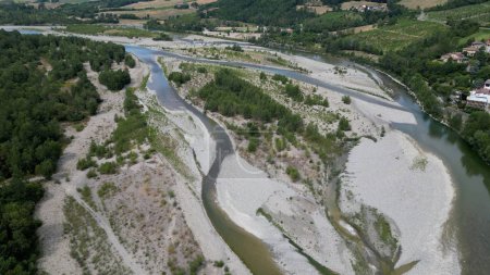 Photo for Europe, Italy , Emilia Romagna Val Trebbia - drone aerial view of river drought and aridity water emergency - climate change and global warming after hurricane and river flood - Royalty Free Image