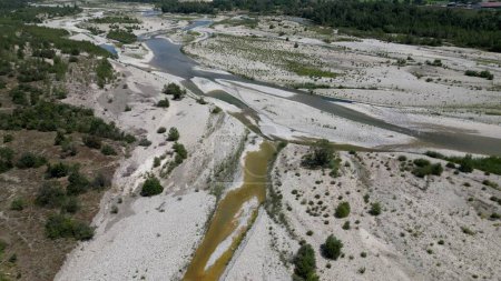 Photo for Europe, Italy , Emilia Romagna Val Trebbia - drone aerial view of river drought and aridity water emergency - climate change and global warming after hurricane and river flood - Royalty Free Image