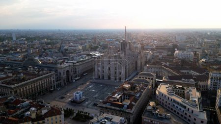 Photo for Europe, Italy, Milan 08-18-23 - Drone aerial view of Piazza Duomo gothic Cathedral in downtown - Duomo Unesco Heritage sightseeing tourist attraction - view of the city during sunrise - Royalty Free Image