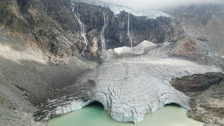 Photo for Europe, Italy, Sondrio Valmalenco Alpe Gera- drone view of Fellaria glacier in Alps - rapid melting of ice iceberg causes sea level rise. Global warming and climate change cause drought and aridity - Royalty Free Image