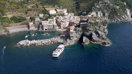 Photo for Europe, Italy, Liguria, Cinque Terre 10-20-23 Drone aerial view of Vernazza - The Cinque Terre popular tourist attraction for tourists from all over the world Unesco Heritage - tourist ferry boat - Royalty Free Image