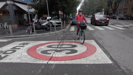 Photo for Europe, Italy , Milan 10-23-2023 - cycle path on the roadside with danger for cyclists bikers in urban traffic increase in fatal accidents and 30 km h speed limit for trucks - Area C - Royalty Free Image