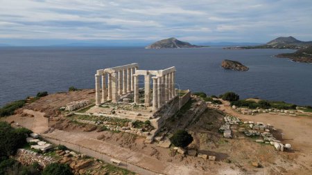 Photo for Temple of Poseidon is one of the most famous monuments in Greece, perched on a rocky Cape Sounion overlooking the Mediterranean sea. - Royalty Free Image