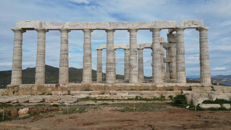 Temple of Poseidon is one of the most famous monuments in Greece, perched on a rocky Cape Sounion overlooking the Mediterranean sea.