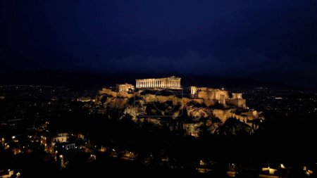  Aerial view of Acropolis in Greece by night , Parthenon in Athens, sigthseeing destination Unesco World Heritage in Atene.