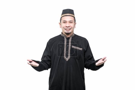 Photo for A handsome Asian Muslim man is welcoming and greeting with a smiling face. - Royalty Free Image