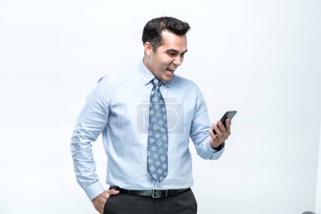 Photo for An Asian working man, dressed in an office worker, is standing and is happy to see his work done on a mobile phone with a smiling face, on white background. - Royalty Free Image