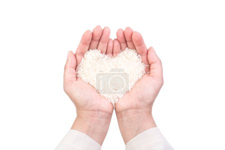 Foto de La mano lleva una pila de arroz en la mano para el concepto zakat islámico. Musulmanes para ayudar a los pobres y necesitados. Sesión conceptual para la propiedad, ingresos y fitrah zakat. - Imagen libre de derechos