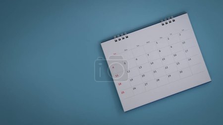 Photo for White calendar laying on blue background planning concept. - Royalty Free Image