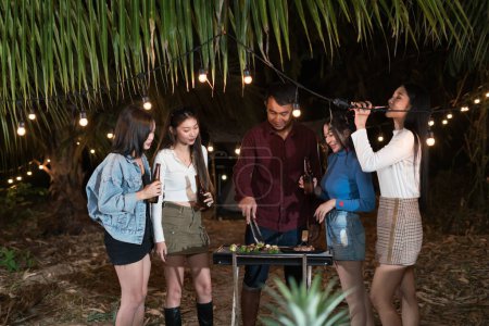 Photo for Group young Asian people enjoying with barbecuing party - Royalty Free Image