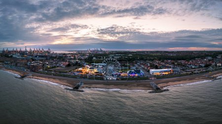 Photo for The seafront and Ferris wheel at dusk in Felixstowe, Suffolk, UK - Royalty Free Image