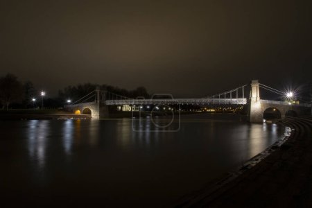 The Wilford Suspension Bridge at night in Nottingham, UK