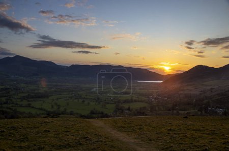 Sunrise behind the hills overlooking Keswick in Cumbria, UK