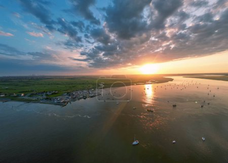 Photo for An aerial view of a spectacular sunset over the River Deben at Bawdsey Beach in Suffolk, UK - Royalty Free Image
