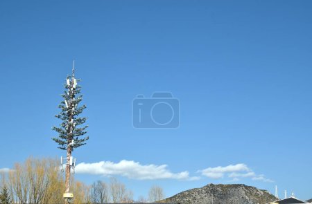 telecommunication pole with flower decoration on cloud and sky in sunny day at China