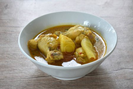 Photo for Chicken drumsticks massaman curry with slice potato and onion on bowl - Royalty Free Image