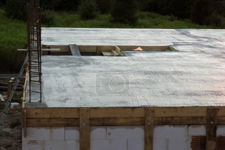 Photo for The slab on the first floor, a steel reinforcement for pillars on the first floor of a house under construction, a wooden formwork, a stairwell rough opening, walls made of aac - Royalty Free Image