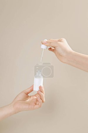 Photo for Beautiful woman's hand is preparing to hold a cosmetic jar, hi res photos - Royalty Free Image