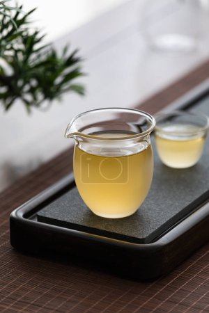 Téléchargez les photos : Image de l'ensemble de thé, personne faisant du thé de style asiatique, tasse de thé et théière - en image libre de droit