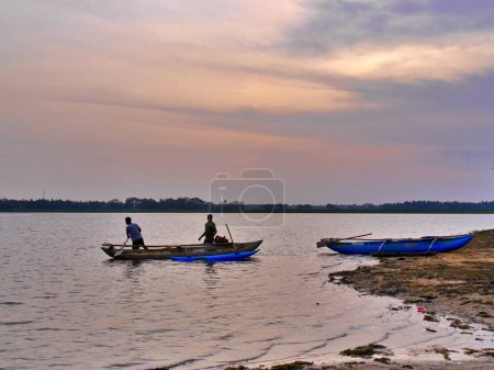 Photo for Men in boats on lake at sunset, Tissamarahama, Sri lanka. High quality photo - Royalty Free Image