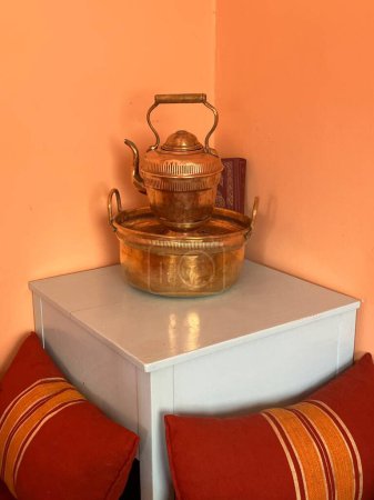 Traditional kettle, cooking pot, cushion and Koran, Essaouira, Morocco. High quality photo