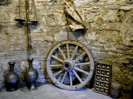 Old, traditional wooden items in stone-walled cellar. High quality photo