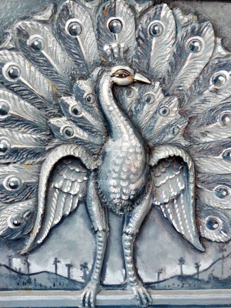 Close up portrait of Peacock engraving, Phnom Sampeau, Battambang, Cambodia. High quality photo