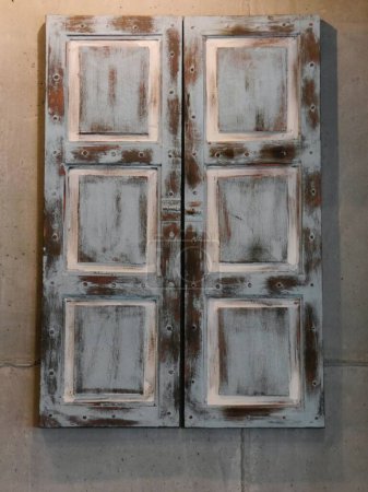 Old distressed window shutters with white paint on brown wood. High quality photo