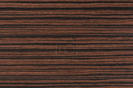 Téléchargez les photos : Macassar wood texture. High quality red and brown macassar wood plank surface texture. The texture of hard and heavy wood, with a beautiful surface for the production of furniture or flooring. - en image libre de droit