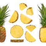 A large set of different parts of pineapple from different angles on a white isolated background. Juicy pineapple, slices with peel and long green leaves, isolated on white. High quality photo
