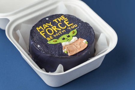 Photo for Kyiv, Ukraine - July 21: Star Wars bento cake with black cream cheese frosting decorated with edible butter cream Master Yoda silhouette and "May the force be with you" text. Dark blue background - Royalty Free Image