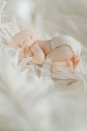 Photo for Christening cake with white cream cheese frosting decorated with mastic newborn baby sleeping on the edible angel wings. Close up of little baby angel sleeping. Baby born celebration. - Royalty Free Image