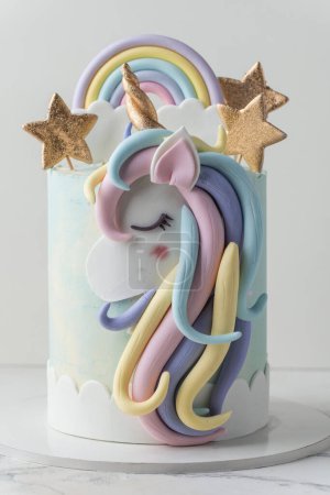 Big cake with turquoise chocolate frosting decorated with golden stars and mastic unicorn silhouette with horn on top. Birthday party unicorn cake for a little girl on the white background.