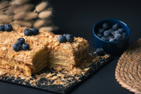 Traditional homemade pastry Honey cake on the black background.
