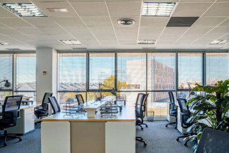 Photo for Empty places for workers in contemporary coworking. Startup business office interior at new workplace. Open space office interior - Royalty Free Image