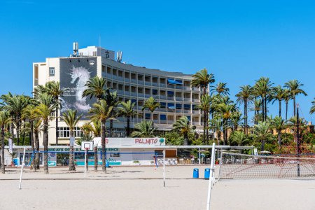 Téléchargez les photos : Javea, Espagne - 24 août 2022 : La plage d'El Arenal pendant l'été. Terrains de beach voleyball sur le sable contre Parador Hotel - en image libre de droit