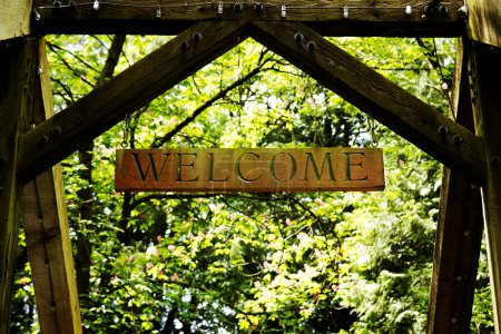 Téléchargez les photos : Panneau de bienvenue en bois sur la porte d'entrée dans les bois - en image libre de droit