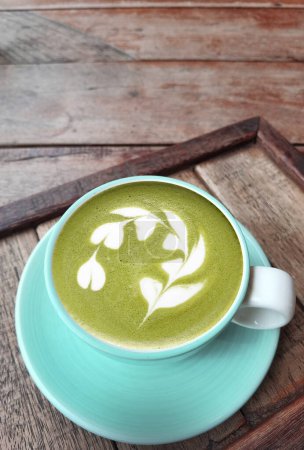 Photo for A cup of green tea matcha latte on wooden background - Royalty Free Image