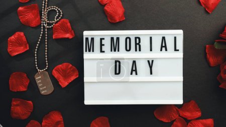 Memorial day background with military plate and red petals.