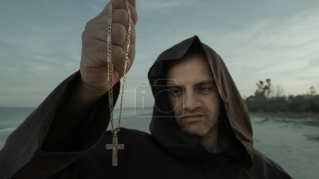 Photo for The Religious Spirit Of The Holy With Crucifix In His Hand. - Royalty Free Image