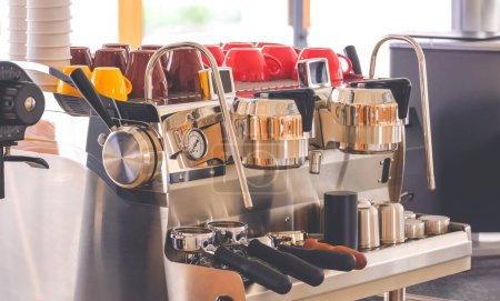 Photo for Automatic electric coffee machine with portafilters and cups on counter inside of modern coffee shop - Royalty Free Image