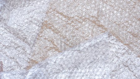 Foto de Colocación plana de plástico blanco envoltura de burbuja sobre fondo de hoja de papel de cartón - Imagen libre de derechos