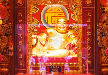 Photo for Bangkok, Thailand - February 22, 2024: Beautiful golden Chinese smiling buddha statue inside of shrine at Wat Mangkon Kamalawat (Wat Leng Noei Yi), Chinatown of Thailand - Royalty Free Image