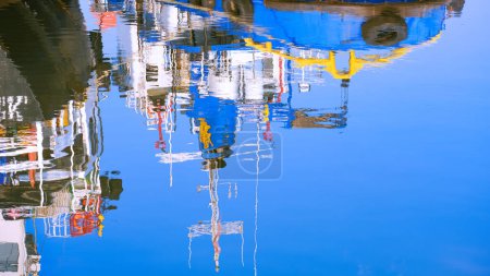 Colorful reflection background of signal antennas and navigation aids of nautical vessel on blue sea surface at harbor