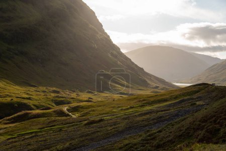 Téléchargez les photos : Coucher de soleil dans une vallée à glen coe dans les Highlands, en Écosse - en image libre de droit