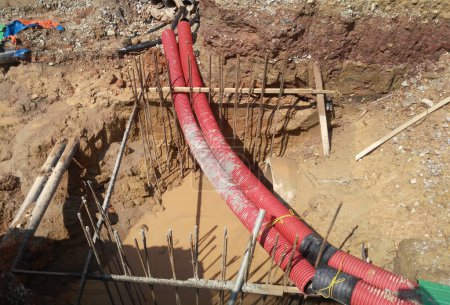Photo for JOHOR, MALAYSIA -MARCH 02, 2017: Underground utility and services pipe lay by workers at the construction site. The pipes used to protect cable lay inside it. - Royalty Free Image